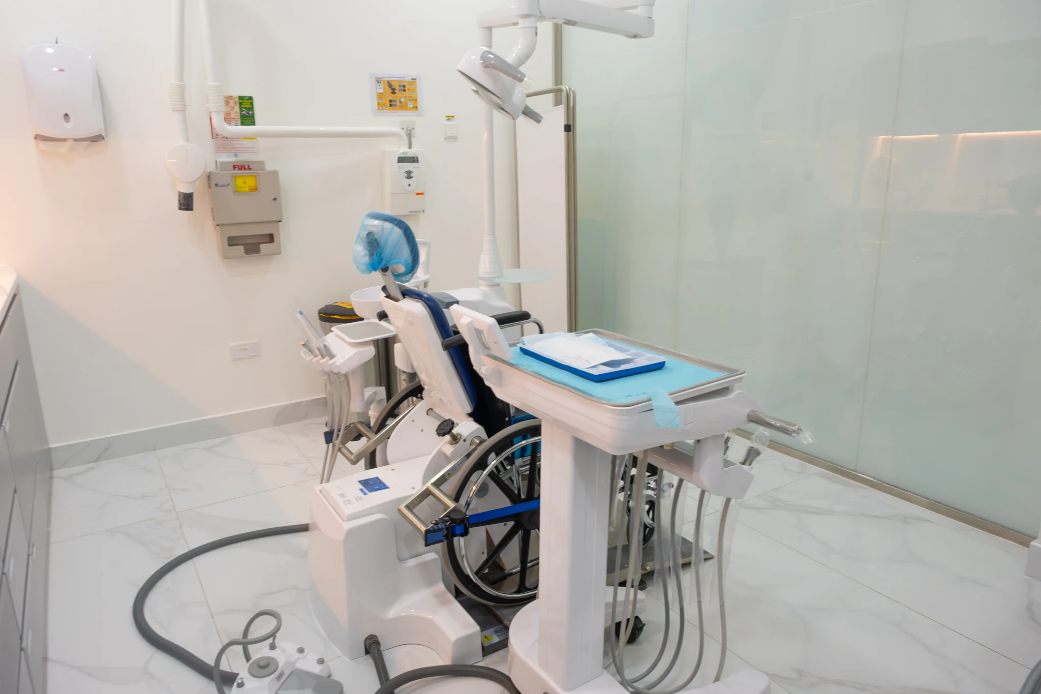 Side view of the wheelchair-accessible dental chair and treatment equipment at Silwadi Al Raha
